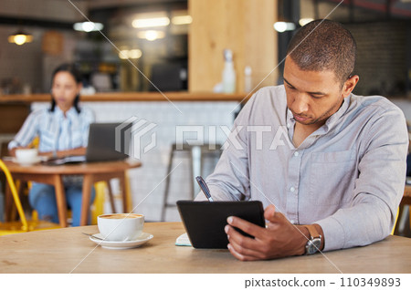 Freelance, business and coffee shop of a man working in a restaurant doing remote work for his startup. Young male entrepreneur using a tablet planning growth strategy in a cafe and writing notes. Freelance, business and coffee shop of a man working in a restaurant doing remote work for his startup. Young male entrepreneur using a tablet planning growth strategy in a cafe and writing notes. 110349893