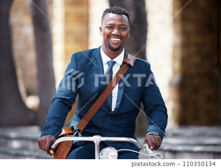 Portrait of a happy businessman on bike or bicycle on his morning travel into work in the city. Employee,, entrepreneur or worker on the ride with decrease his carbon footprint with a suite and smile 110350134