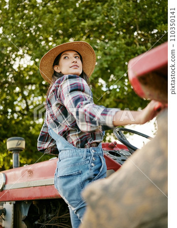 Woman agriculture worker or farmer on tractor working farm during harvest time. Sustainability farming in the countryside. Serious girl farming in a field, fresh produce for farmers market Woman agriculture worker or farmer on tractor working farm during harvest time. Sustainability farming in the countryside. Serious girl farming in a field, fresh produce for farmers market 110350141