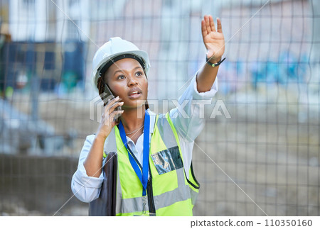 Construction worker, maintenance and development woman multitask on a phone while working. Building management employee on a work call helping holding up a hand on a contractor and builder job site 110350160
