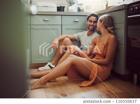 Couple, in love and on kitchen floor looking into their eyes on luxury real estate. Man, woman and communication and a conversation in a new home, house or room before breakfast with family. Couple, in love and on kitchen floor looking into their eyes on luxury real estate. Man, woman and communication and a conversation in a new home, house or room before breakfast with family. 110350637