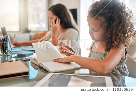 Distance learning, independent or child development of a little girl studying from home and writing in a notebook. Young child doing online education with a busy mother or single parent 110350639