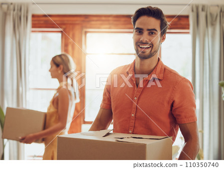 Happy couple moving into new home, people carrying boxes to property and relocating to apartment together. Portrait of smiling, cheerful and handsome man packing for move with woman standing at house 110350740