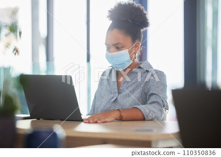Covid, face mask and a black woman working on a laptop in a modern office. Sick businesswoman on the internet at work. College student, online exam and in campus library, protected against the virus. Covid, face mask and a black woman working on a laptop in a modern office. Sick businesswoman on the internet at work. College student, online exam and in campus library, protected against the virus. 110350836