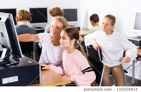 Teenagers in computer class 110350933
