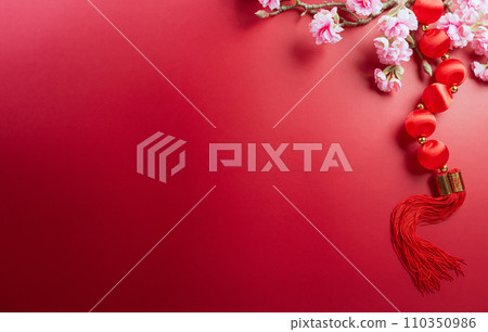 Chinese new year decorations made from plum blossom and gold ingots or golden lump. Chinese characters on the object means to fortune, good luck, wealth, and money flow. 110350986