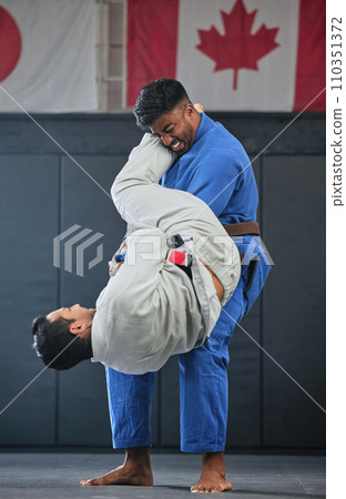 . Mma, training and fighting with a student and teacher exercising during a self defense workout in a gym or fight studio. Combat sport with a fighter and his opponent in gi or uniform in a match. 110351372