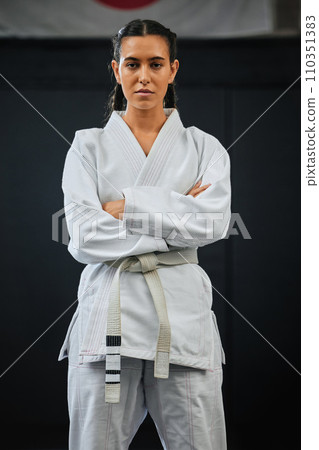 . Karate pro, women empowerment and training mindset of a serious, learning sport student. Portrait of a fight and fitness athlete with focus in a sports studio, dojo school or martial arts gym. 110351383