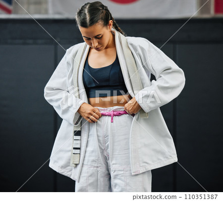. Karate woman ready for fitness workout at gym, learning at a sport club and doing training exercise at a wellness school or studio. Female dojo student preparing for fighting competition at center. 110351387
