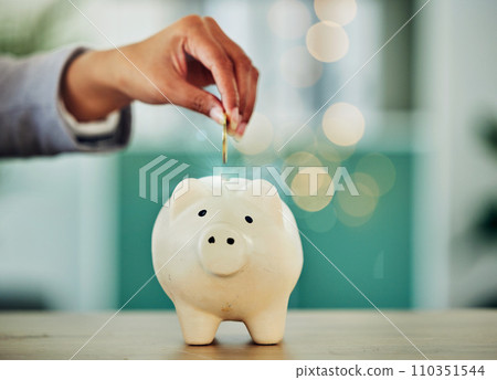 . Saving and investment for future, hand putting a coin into a piggy bank, money growth and financial freedom. Retirement, insurance and budget security of woman banking money away. . Saving and investment for future, hand putting a coin into a piggy bank, money growth and financial freedom. Retirement, insurance and budget security of woman banking money away. 110351544