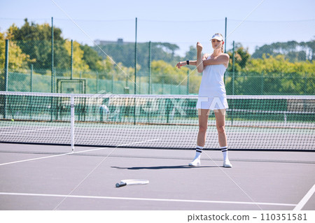 Fitness, tennis player and athlete stretching out arms before an exercise match, game or workout outside on the court. Young, active and sporty female in a sports club warming up ready for training Fitness, tennis player and athlete stretching out arms before an exercise match, game or workout outside on the court. Young, active and sporty female in a sports club warming up ready for training 110351581