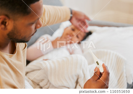 Sick, cold and flu of sick child with caring and loving parent taking temperature of his daughter. Father on family responsibility leave to care, love and treat his little girl with fever at home. 110351650