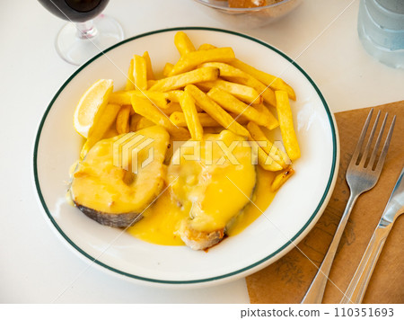 Stewed hake Merluza en salsa holandesa with potatoes Stewed hake Merluza en salsa holandesa with potatoes 110351693