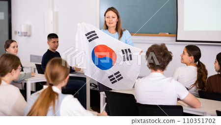Female professor shows students flag of South Korea Female professor shows students flag of South Korea 110351702