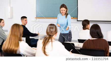 Positive adult female teacher leading a lesson 110351704