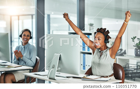Call centre, cheerful and agent celebrating with arms up at her office desk. Successful, professional and positive customer review or bonus. Helpdesk worker excited with salary performance increase. 110351770