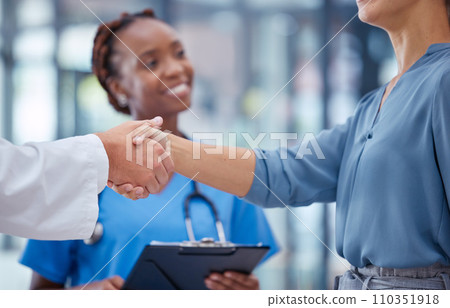 Doctors handshake thank you, greeting or good medical breakthrough success with smiling nurse in background. Physician, healthcare worker and patient shaking hands for innovation in health research 110351918