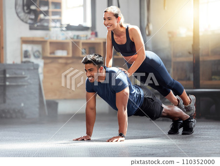 Fitness, strong and wellness couple exercising, training or workout exercise inside gym. Sporty professional woman and man or trainer doing pushup and balance in a physical endurance session Fitness, strong and wellness couple exercising, training or workout exercise inside gym. Sporty professional woman and man or trainer doing pushup and balance in a physical endurance session 110352000