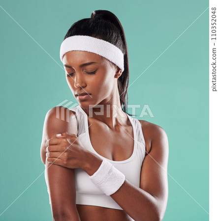 Tennis player with sports injury, hurt or pain in her arm after practice against green studio background. Professional female athlete suffering muscle strain, accident and inflammation on her body Tennis player with sports injury, hurt or pain in her arm after practice against green studio background. Professional female athlete suffering muscle strain, accident and inflammation on her body 110352048