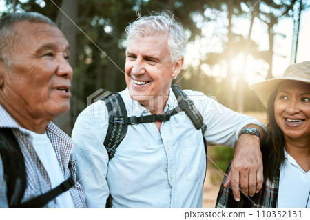 Hiking, adventure and exploring with a group of senior friends and retired adults enjoying a hike or walk outdoors in nature. Enjoying the view while on a journey of discovery in the forest or woods 110352131