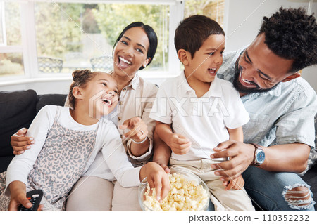 Family watching tv or a movie, having fun and eating popcorn together at home. Love and laughter with affectionate parents and happy children smiling, enjoying the weekend and feeling carefree Family watching tv or a movie, having fun and eating popcorn together at home. Love and laughter with affectionate parents and happy children smiling, enjoying the weekend and feeling carefree 110352232