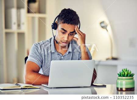 . Bored, tired and working customer service web support worker on an online computer call. Internet helpdesk male employee with a headset and headache feeling overworked from digital consulting job. . Bored, tired and working customer service web support worker on an online computer call. Internet helpdesk male employee with a headset and headache feeling overworked from digital consulting job. 110352235