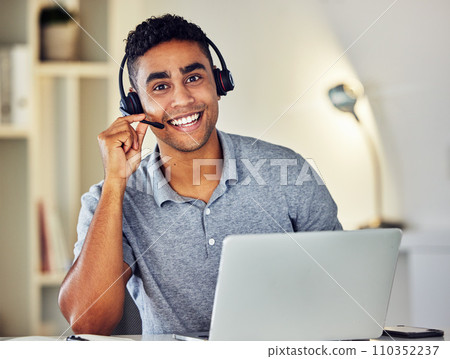 . Friendly call center, online or tech support worker who helps clients, customers and callers. Man on a laptop, with a headset and working as a customer service professional from home portrait. . Friendly call center, online or tech support worker who helps clients, customers and callers. Man on a laptop, with a headset and working as a customer service professional from home portrait. 110352237