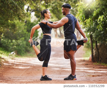 Young fit couple exercising outdoors together, bonding while stretching and preparing for a cardio workout. Athletic girlfriend and boyfriend being affectionate while training and staying healthy 110352299