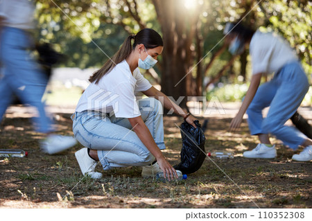 Volunteer, recycle and reduce waste by picking up litter, dirt and garbage outdoors in a park during covid. A young team of female NGO activists cleaning the environment during the covid19 pandemic Volunteer, recycle and reduce waste by picking up litter, dirt and garbage outdoors in a park during covid. A young team of female NGO activists cleaning the environment during the covid19 pandemic 110352308