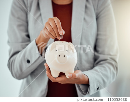 Banking, finance and money in piggybank for savings, investment and growth for business woman. Closeup of hands of a corporate professional putting coins into a tool to save, insurance and security 110352688