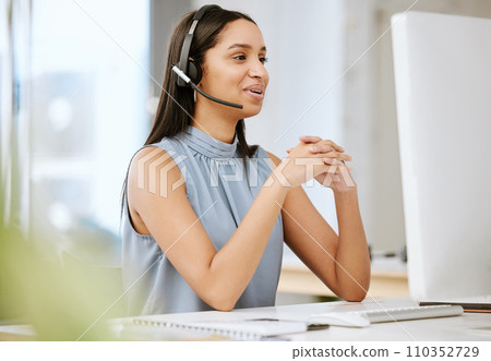 Call center agent, customer service and sales support operator with headset giving friendly help and good advice while working on computer. Smiling, happy and cheerful consultant talking on hotline 110352729