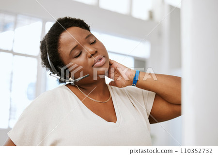Stressed, neck pain and tired call center agent stretching bad, strained or sore muscle while working with headset. Female ecommerce support consultant working overtime or sitting long hours at desk Stressed, neck pain and tired call center agent stretching bad, strained or sore muscle while working with headset. Female ecommerce support consultant working overtime or sitting long hours at desk 110352732