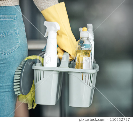 Domestic worker, maid or cleaner hands holding or carrying cleaning products and equipment or supplies. For home hygiene, contact us for a handy helper agency or professional household service. 110352757