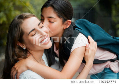 Happy, smiling and young daughter kissing her mother, hugging and greeting before school in the morning. Loving, caring and cheerful parent embracing, holding and giving goodbye hug to little girl 110352774