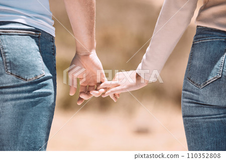 Affectionate couple holding hands showing love, caring and bonding outside together in nature. Loving boyfriend and girlfriend expressing unity, understanding and trust in their relationship Affectionate couple holding hands showing love, caring and bonding outside together in nature. Loving boyfriend and girlfriend expressing unity, understanding and trust in their relationship 110352808