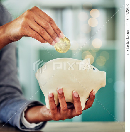 . Savings, investment or a woman putting a coin into a piggybank for financial growth and freedom. Closeup of a female investing in her future or retirement fund for insurance and budget security. 110352898