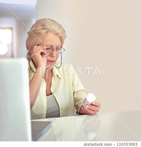 Making sure shes taking the right dose. a senior woman checking her medication at home. 110353003