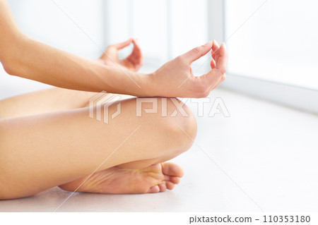 Yoga, floor and hands of person meditate for calm inner peace, chakra awareness balance and practice aura healing. Lotus position, pilates and closeup yogi relax for mindfulness, mindset or wellness 110353180
