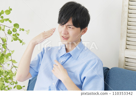 A man using a hand fan at home A man using a hand fan at home 110353342
