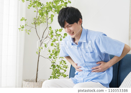 A man with stomach pain at home A man with stomach pain at home 110353386