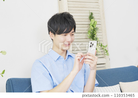 man using smartphone at home 110353465