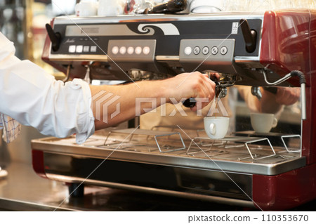 Coffee machine, closeup and man barista in a cafe making latte, cappuccino or espresso in a cup. Equipment, mug and zoom of male waiter or small business owner working on an order in a restaurant. Coffee machine, closeup and man barista in a cafe making latte, cappuccino or espresso in a cup. Equipment, mug and zoom of male waiter or small business owner working on an order in a restaurant. 110353670