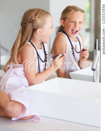 Kid, lipstick and smile for mirror in bathroom with mark, writing or drawing with bad behavior. Little girl, happy and laugh for picture, naughty and problem with mom, makeup or cosmetics for beauty 110353856
