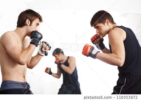 Men, fighting and martial arts training in ring with sparring partner for self defense techniques at dojo. Male person or fighter in kick boxing, karate or MMA for jujitsu match, sports or face off 110353872
