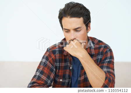 Man, thinking and serious or hands for question, idea and contemplating in living room of apartment or home. Person, face and mental health or thoughtful on couch in lounge for anxiety or nervous Man, thinking and serious or hands for question, idea and contemplating in living room of apartment or home. Person, face and mental health or thoughtful on couch in lounge for anxiety or nervous 110354112