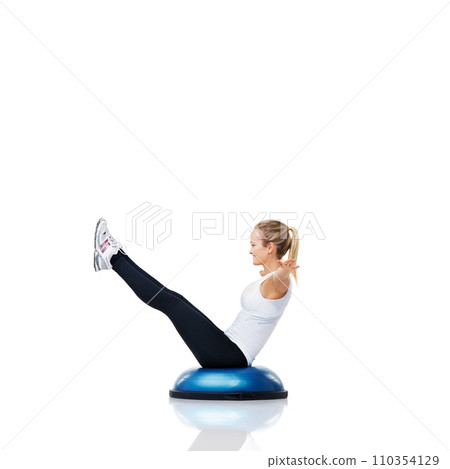 Woman, exercise and balance on bosu ball for core training, muscle and workout isolated on white background. Fitness equipment, strength and endurance with mockup space and strong athlete in studio Woman, exercise and balance on bosu ball for core training, muscle and workout isolated on white background. Fitness equipment, strength and endurance with mockup space and strong athlete in studio 110354129