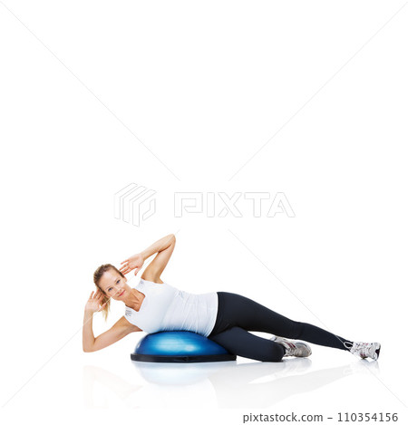 Portrait of woman, bosu ball or balance in studio or core workout isolated on white background. Female athlete, training equipment or fitness for mockup space, body challenge or exercise for wellness Portrait of woman, bosu ball or balance in studio or core workout isolated on white background. Female athlete, training equipment or fitness for mockup space, body challenge or exercise for wellness 110354156
