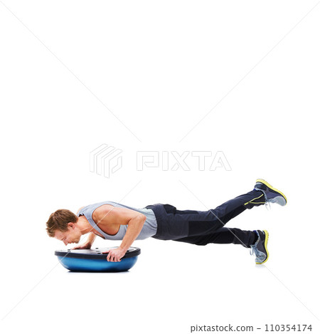 Man, training and push ups with bosu ball for fitness, exercise or workout on a white studio background. Active male person lifting body weight for strength, muscle or strong arms on mockup space Man, training and push ups with bosu ball for fitness, exercise or workout on a white studio background. Active male person lifting body weight for strength, muscle or strong arms on mockup space 110354174