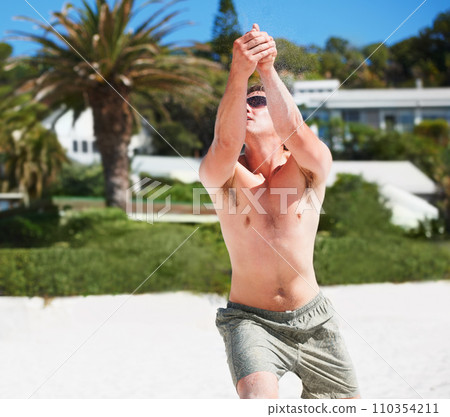 Volleyball, training and man at beach in competition, game or match in summer outdoor. Sports, fitness and athlete at shore for exercise, workout and practice for healthy body, wellness and energy 110354211