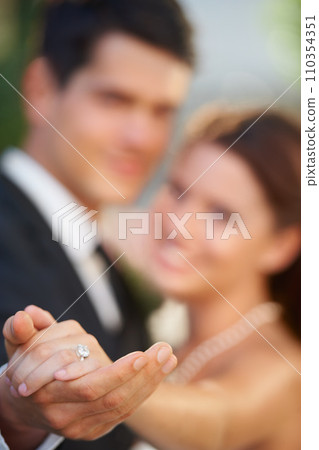 Hands, ring and a couple on their wedding day for love, romance or celebration at a marriage ceremony. Trust, commitment or promise with a bride and groom together at an event to get married closeup 110354351